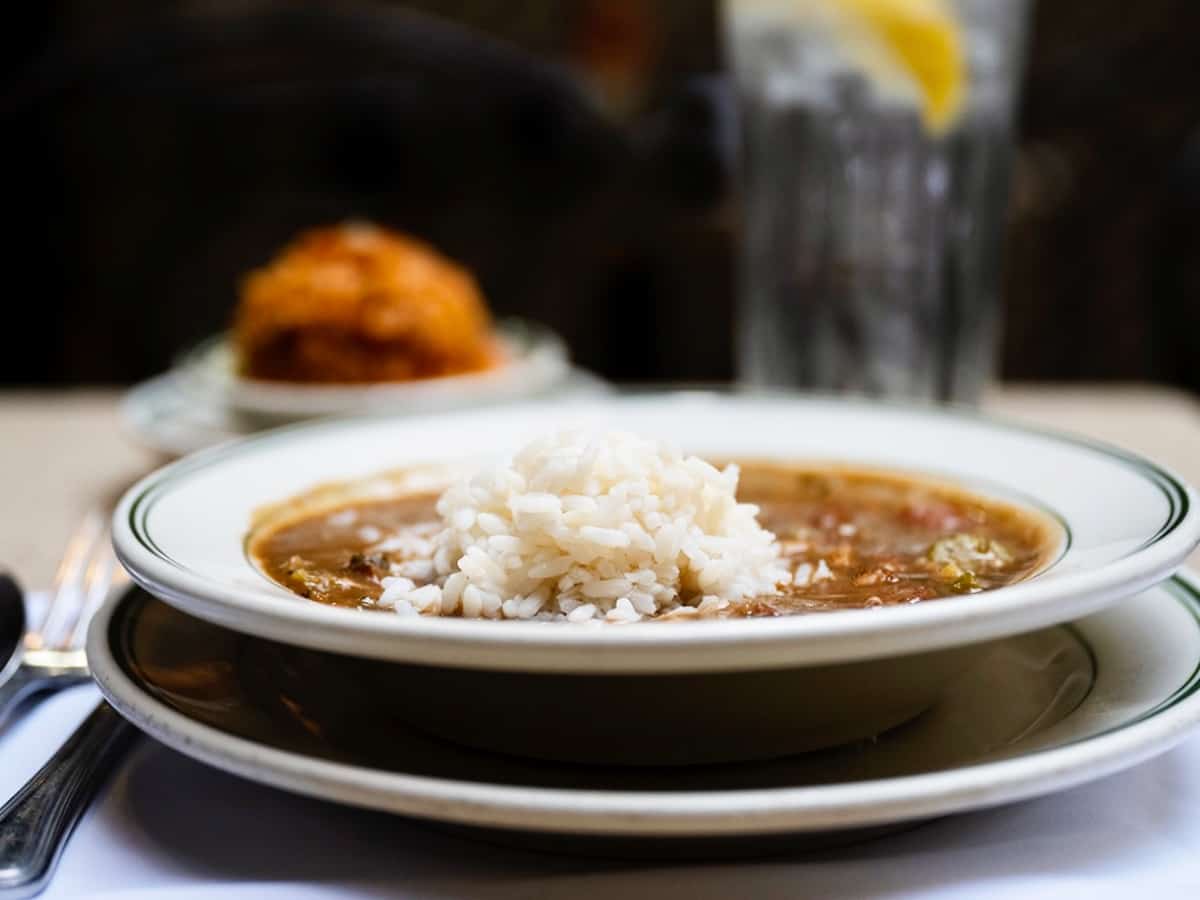 Bowl of gumbo with utensils.