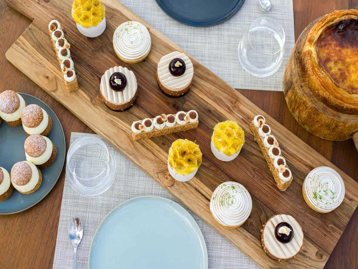 A variety of small desserts on wood on table. A variety of small desserts on wood on table.