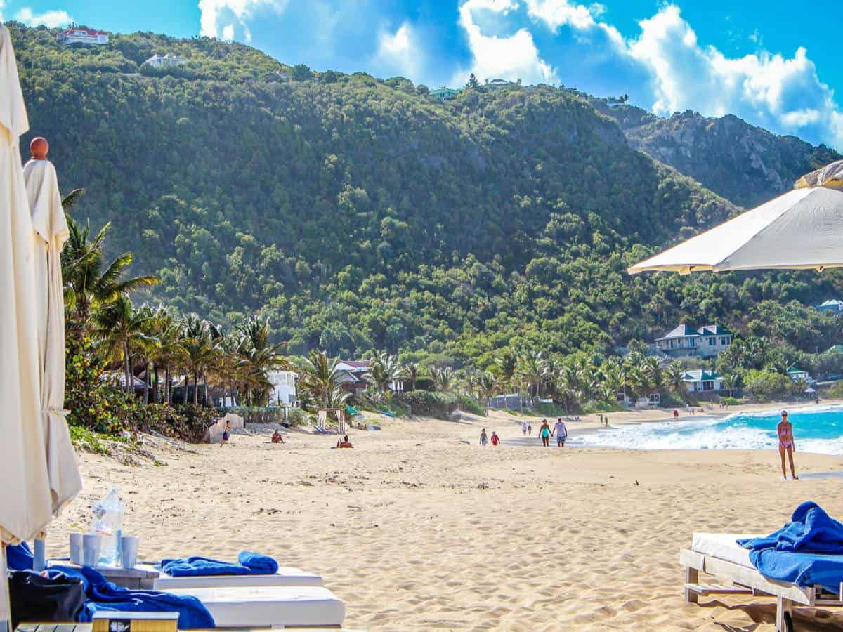 Sandy beach in St. Barts with people walking. Sandy beach in St. Barts with people walking.