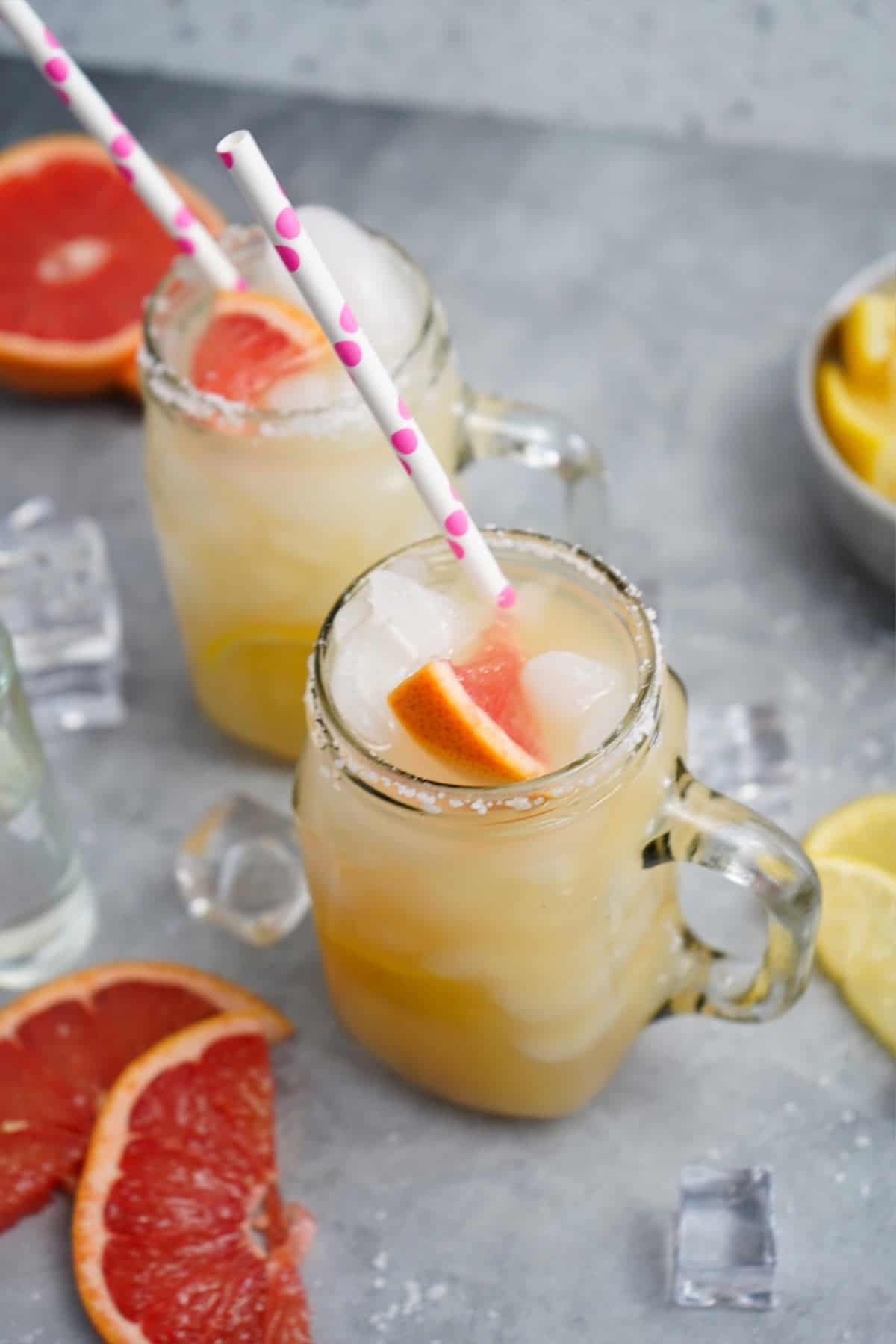 Two glasses of mezcal paloma cocktail on the table.