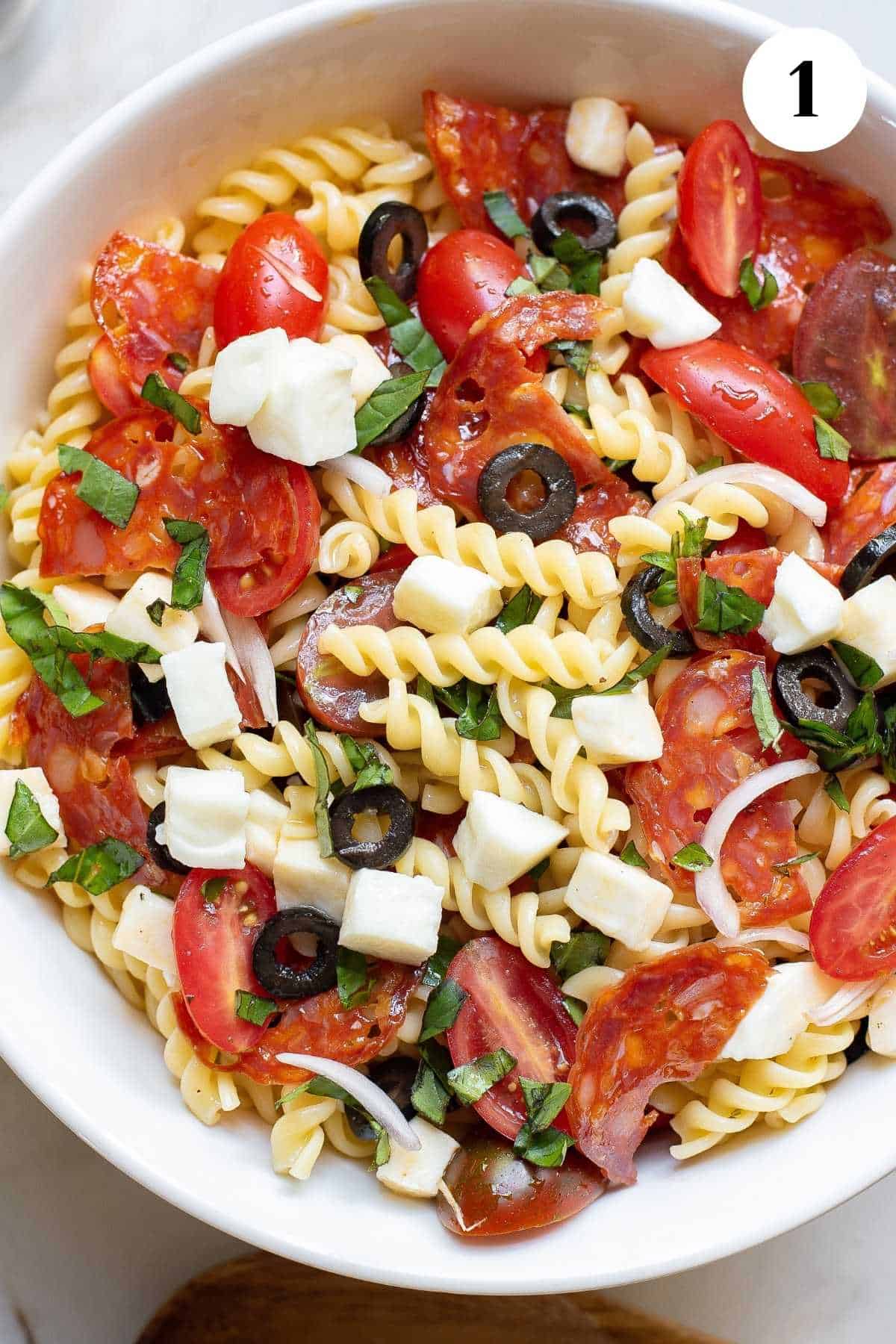 A bowl of pizza salad on the table ready to add dressing.