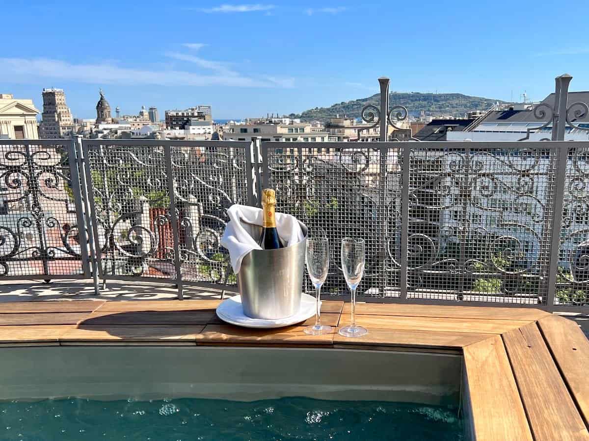 A bottle of cava on the terrace of the penthouse suite with views over Passeig de Gracia at Hotel Majestic, Barcelona.