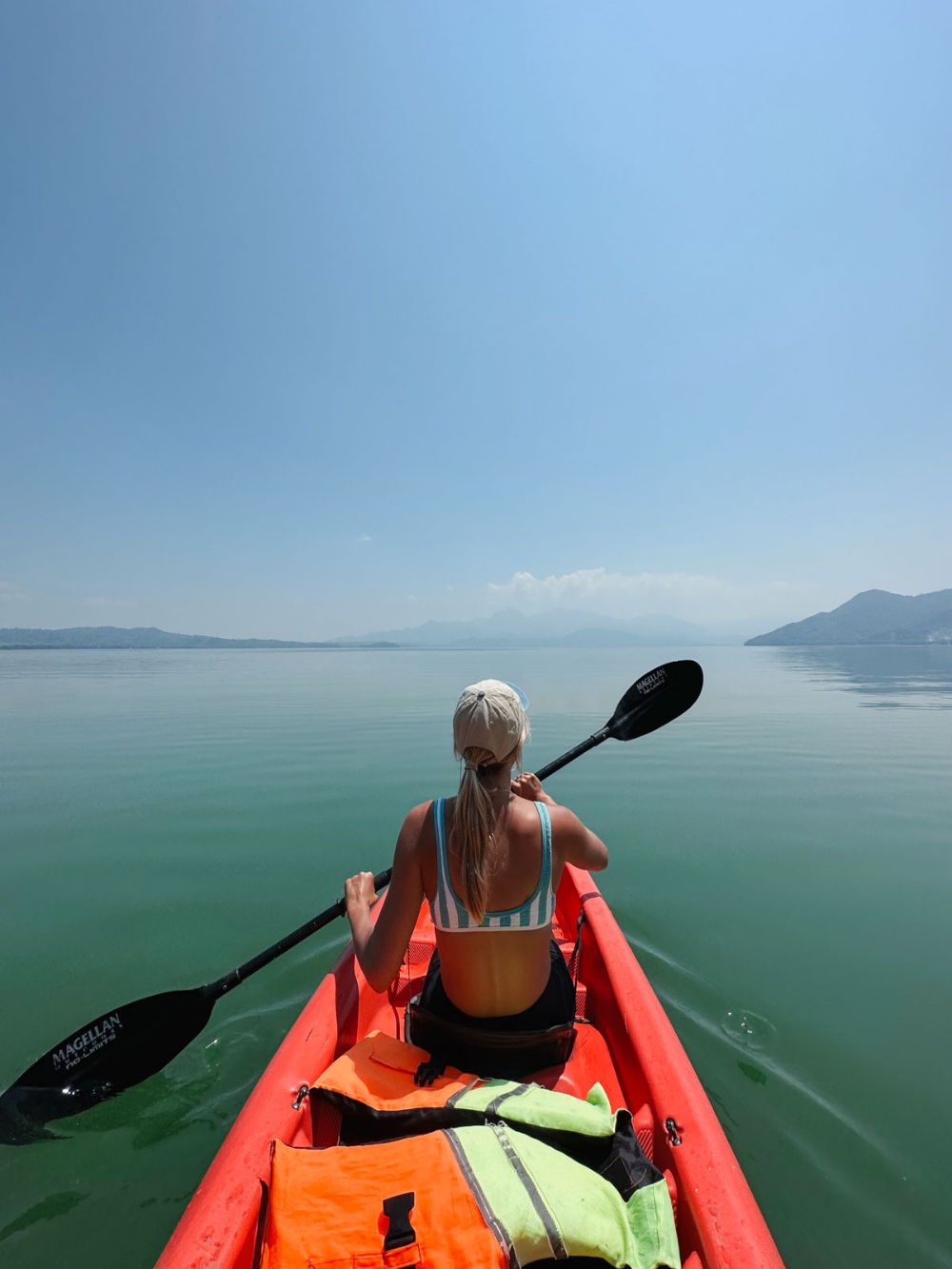 A woman kayaking  on Lake Yojoa.