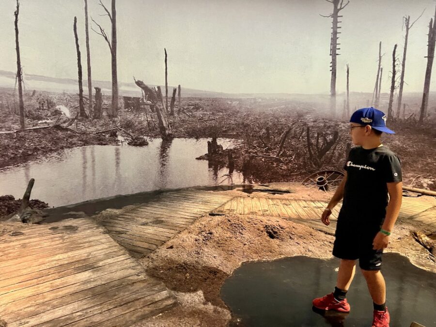 Young boy walking at the World War 1 exhibit of the battlefield of Ypres 1915 at the Canadian War Museum. 