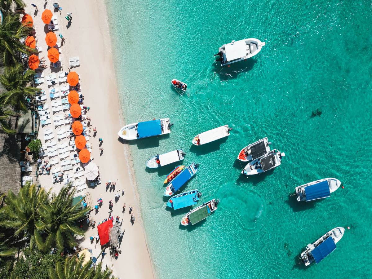 Aerial view of Caribbean beach in Honduras with boats.