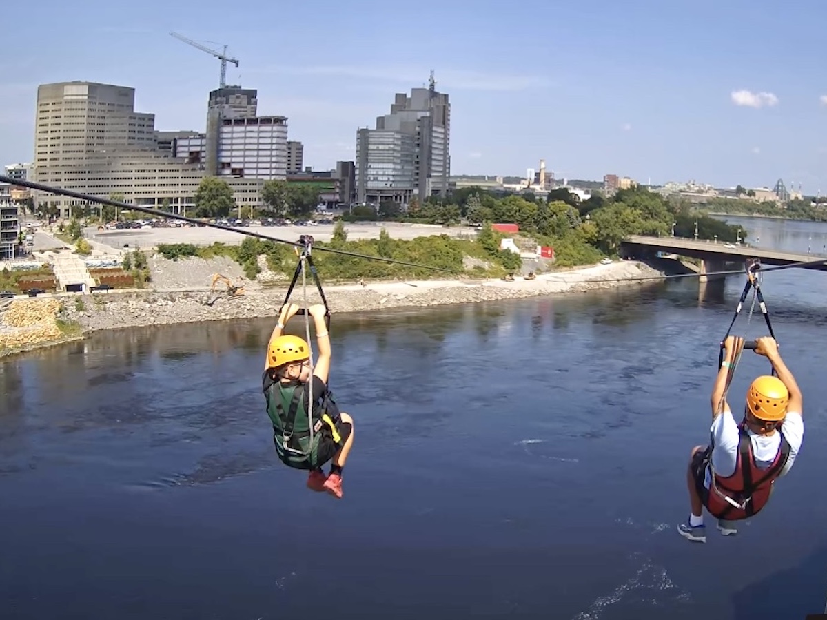 A grandpa and grandson ziplining in Ottawa with InterZip.