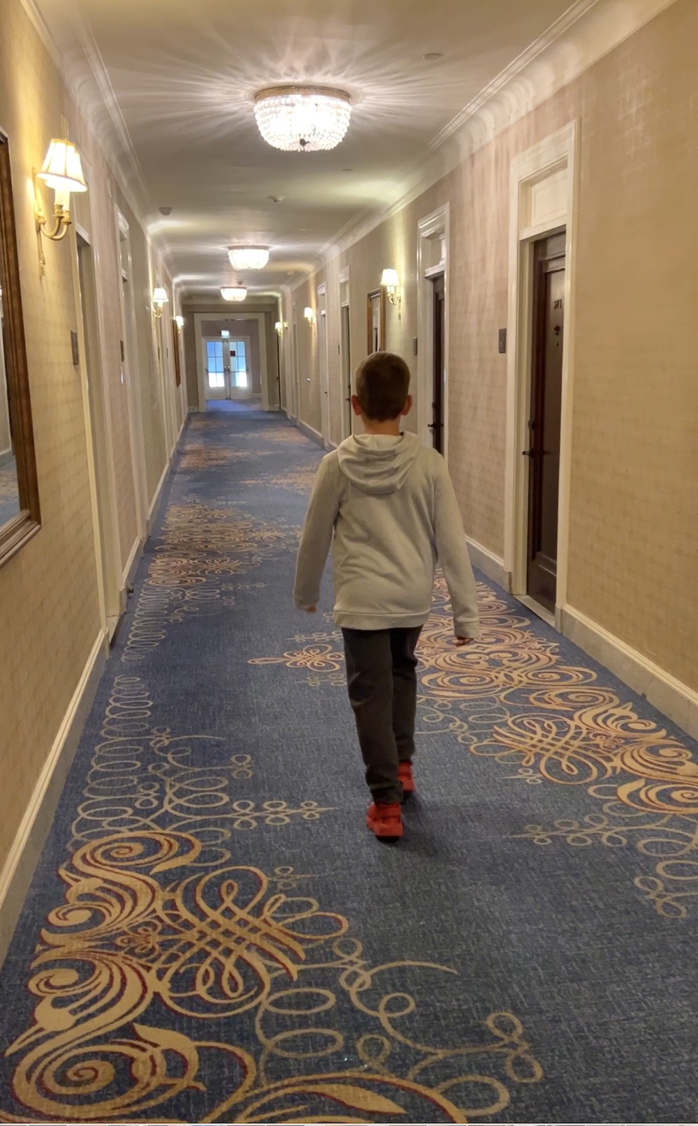 Young child walking in the hallway at the Fairmont Chateau Laurier. 