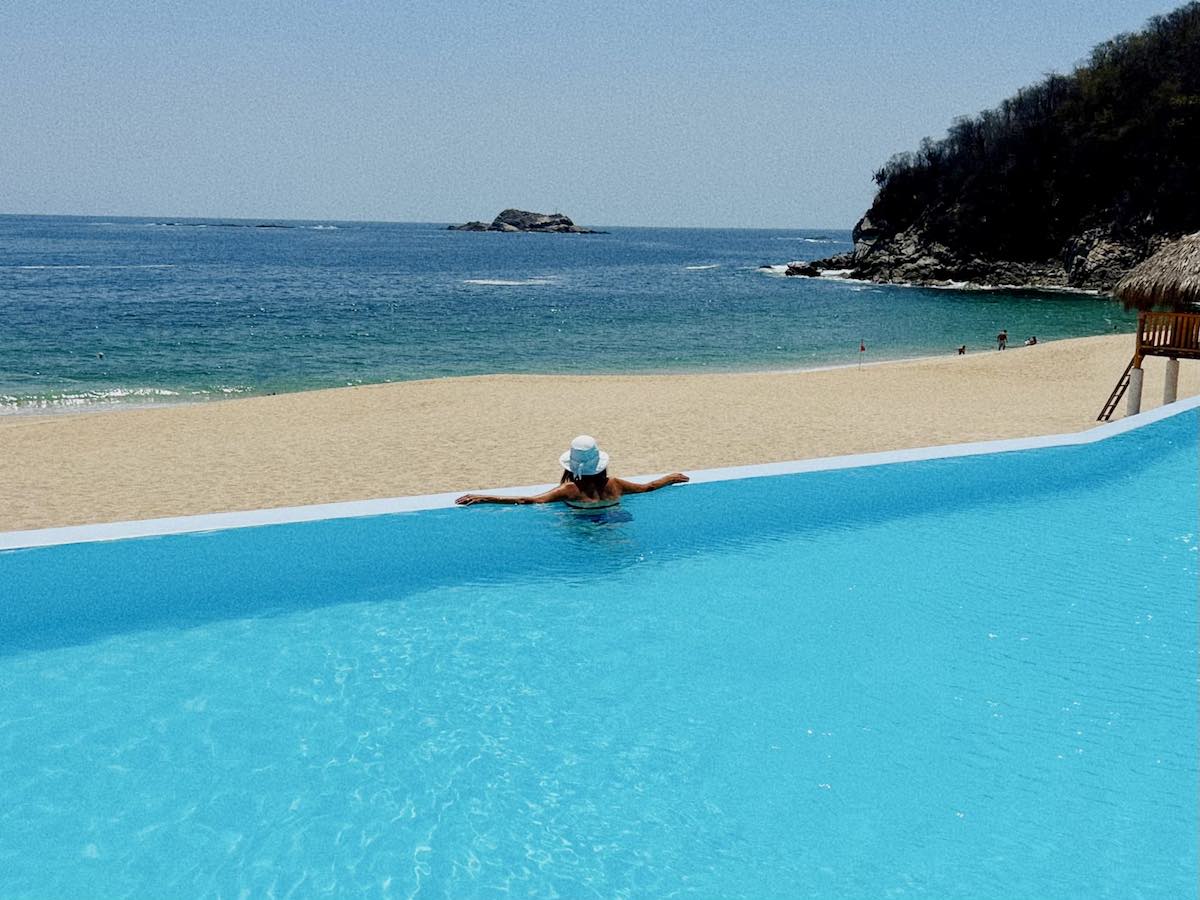 Woman in the infinity pool at SEa Soul Beach Club at Chahue Beach. 