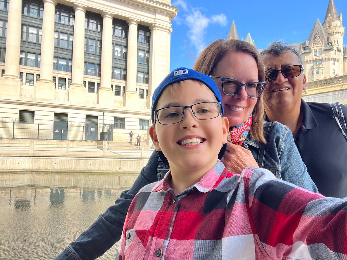 Family in Ottawa in front of Rideau Canal. 