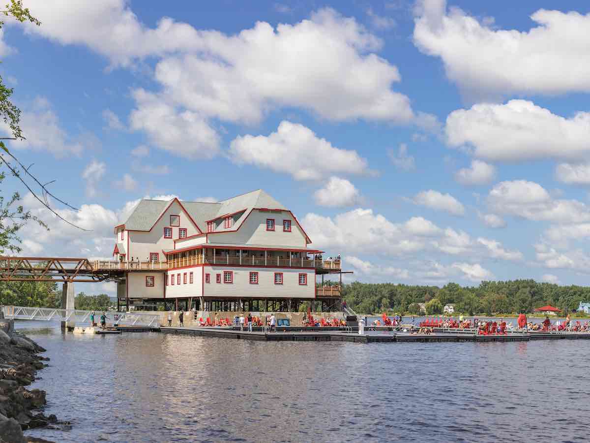 People swimming at the public dock at the century-old NCC Riverhouse on the Ottawa River. (Credit: National Capital Commission)  