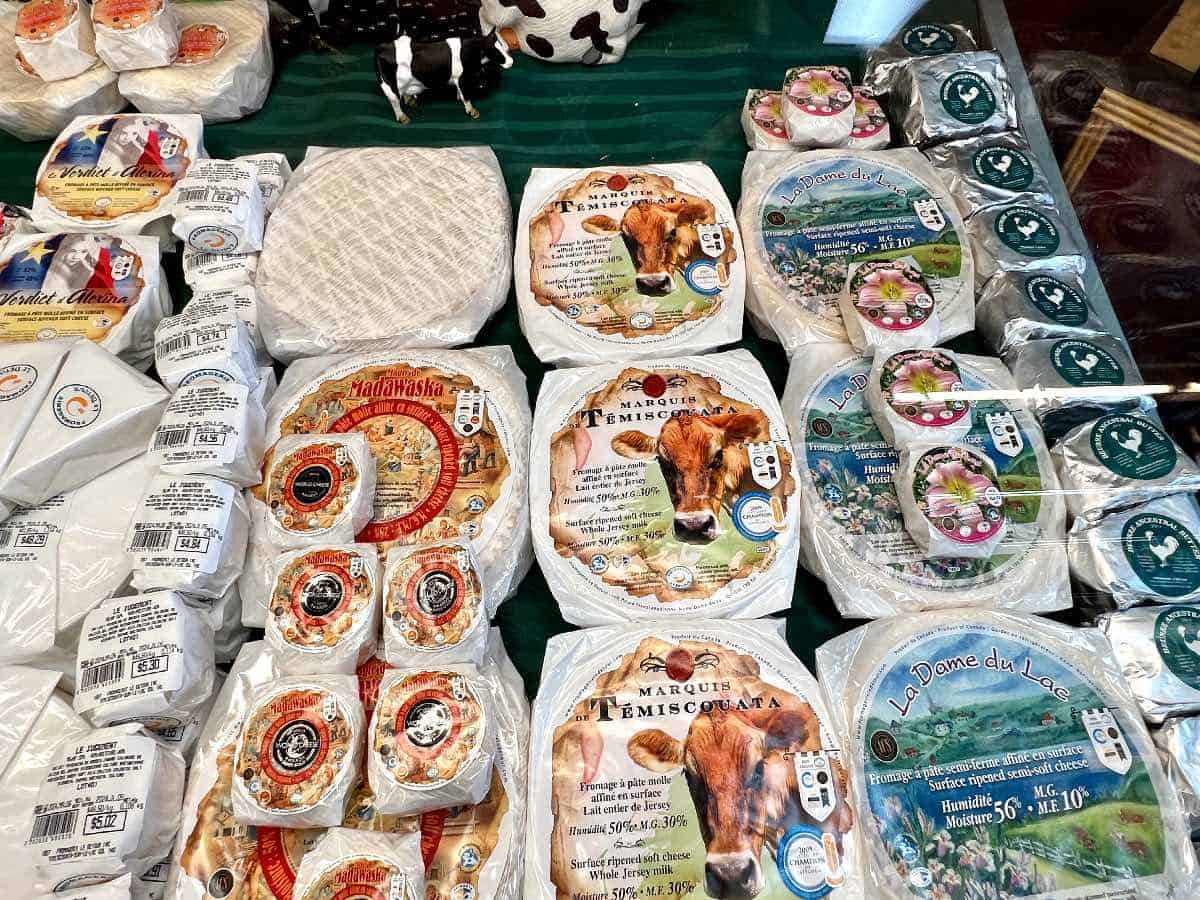 Different cheeses on table at factory.