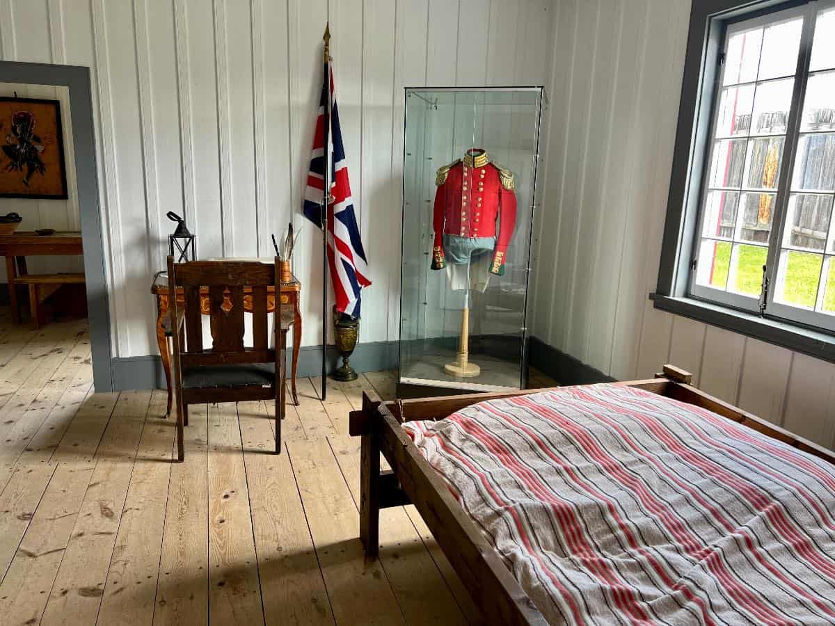 Living quarters at Fort Ingall with bed and chair.