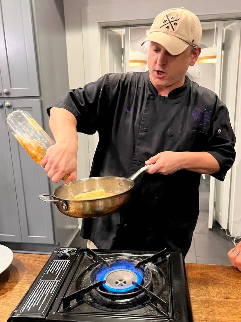 Mardi Gras School of Cooking hef Mark Falgoust flambées bananas for Bananas Foster.