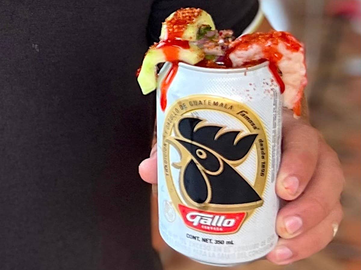 Picosita beer cocktail garnished with cucumber and shrimp in a Gallo beer can.