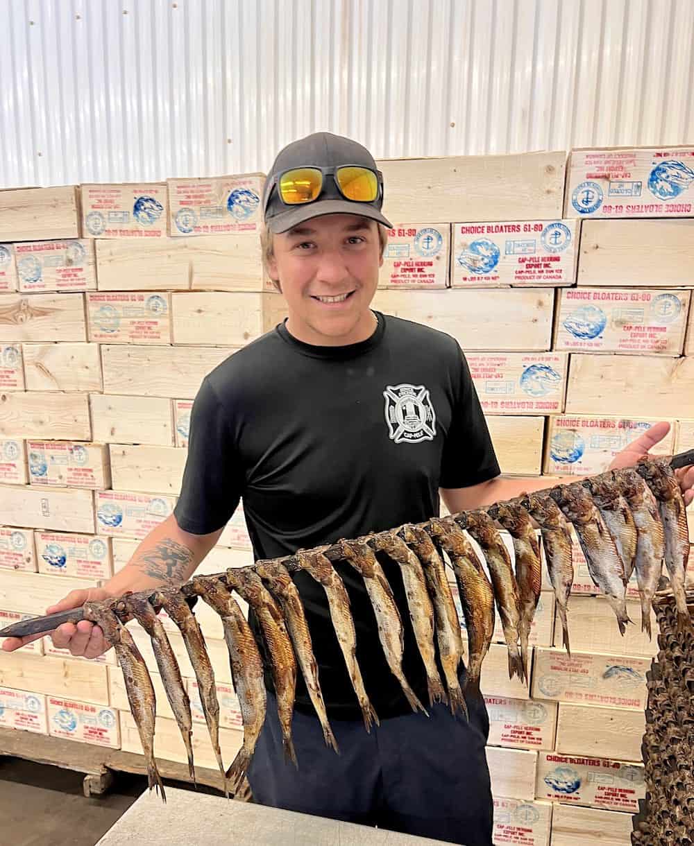 In Cap-Pelé smokehouses, herring are strung on long poles called cannes for smoking.