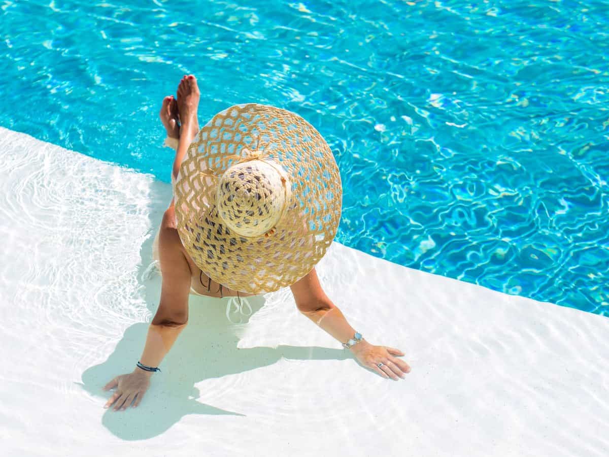 Woman lounging by a swimming pool in Mexico. 