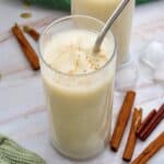 A glass of Guatemalan horchata with a few sticks of cinnamon.