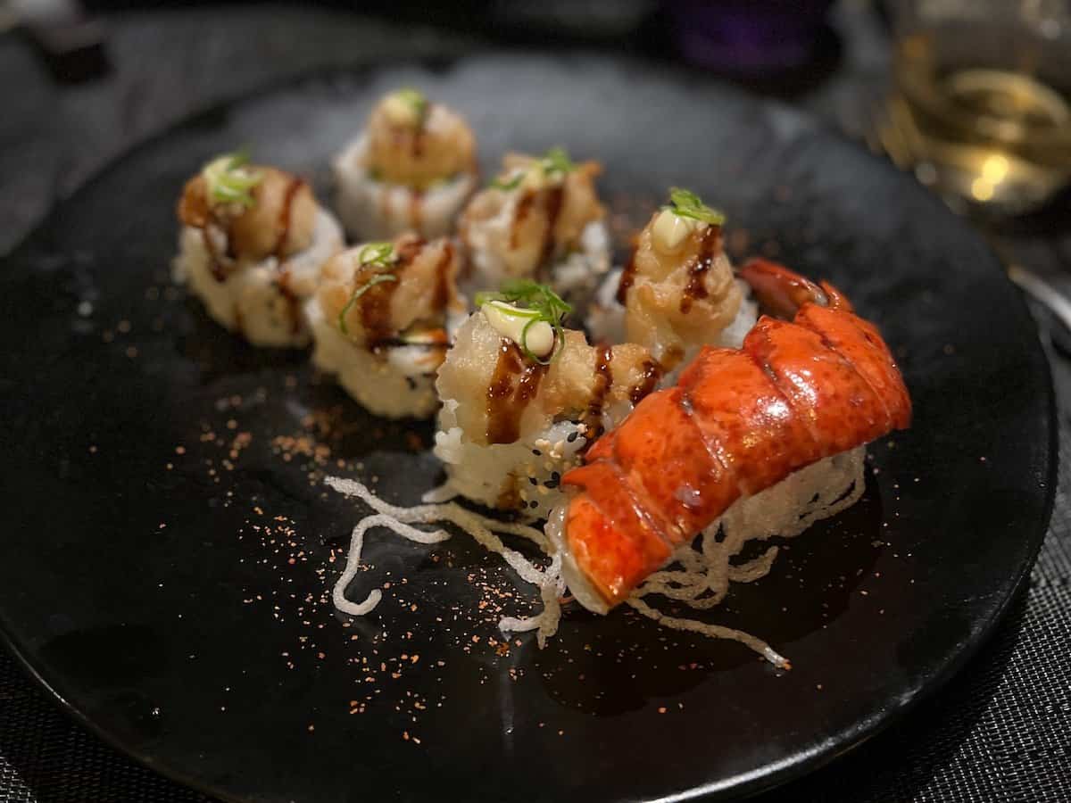 Sophisticated Japanese cuisine on a black dish.