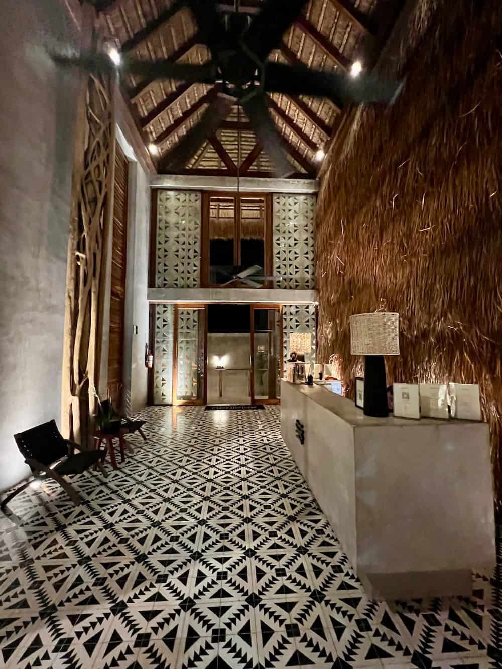 Lobby of Amainah Bacalar Hotel at night.