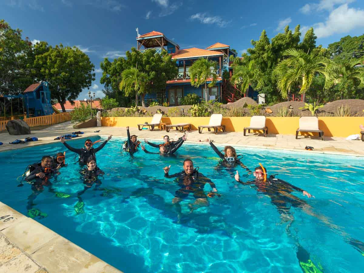 Divers in a pool. Credit True Blue Bay.