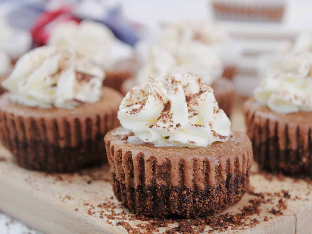 A mini Kahlua cheesecake on a wooden board.